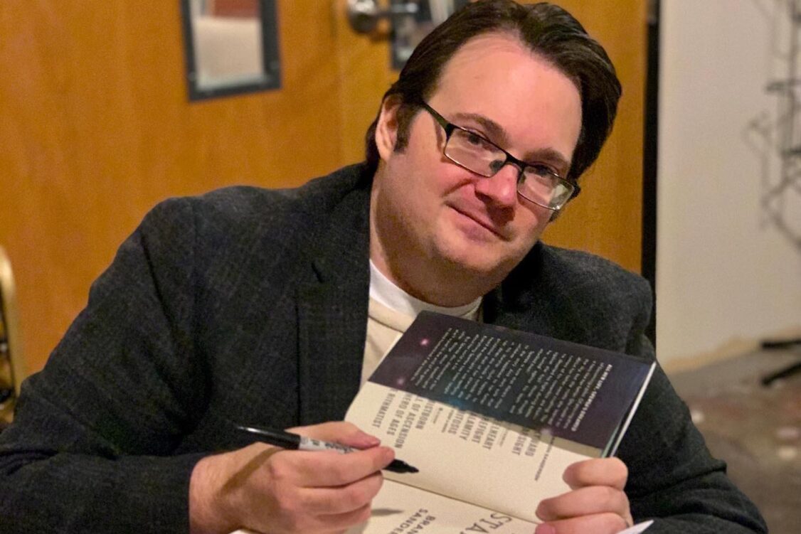 Brandon Sanderson signs a book