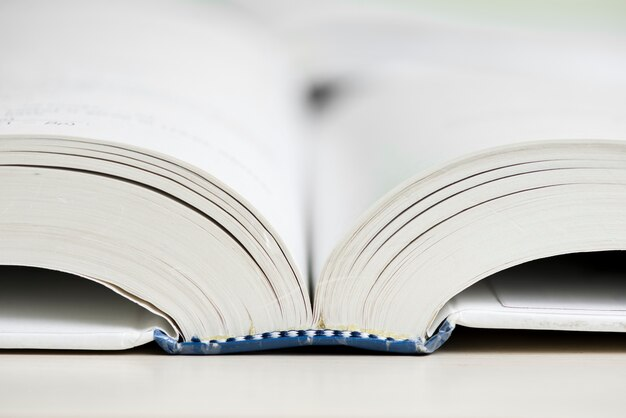 The book rests on a table with bookmarks and a pen and pencil